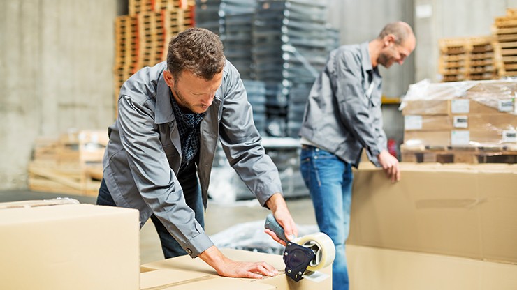 Peak Holiday Hours Blog Photo Image of Worker Taping up a Box