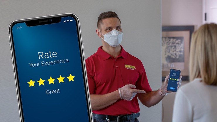 final mile carrier showing rating app to customer A final mile driver points at a cell phone with rating system