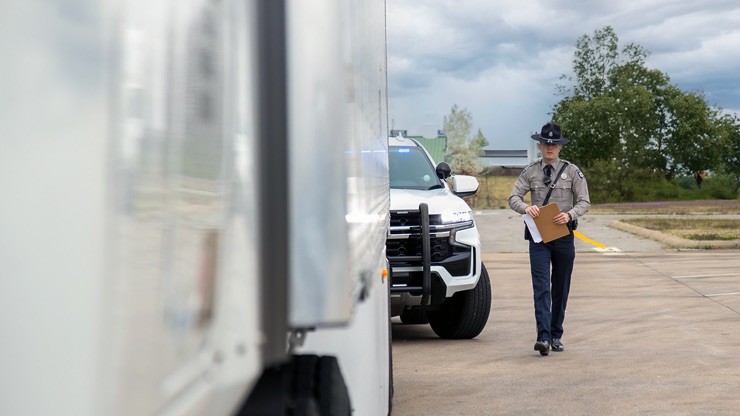 officer approaching trailer