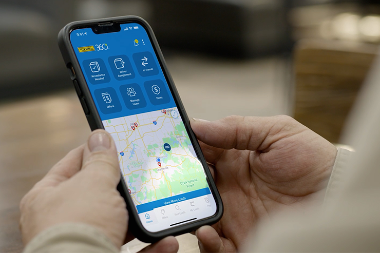 Person holding iPhone with J.B. Hunt 360 App