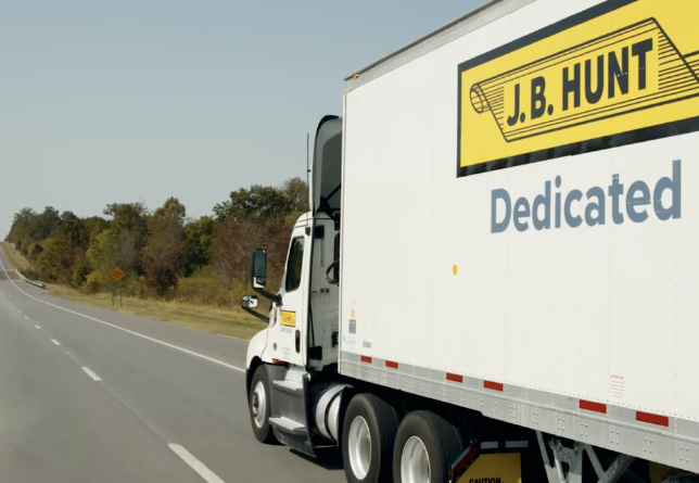 dedicated truck driving down the highway