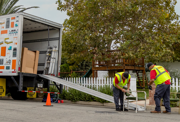 Final Mile employees assembling furniture outside of a box truck