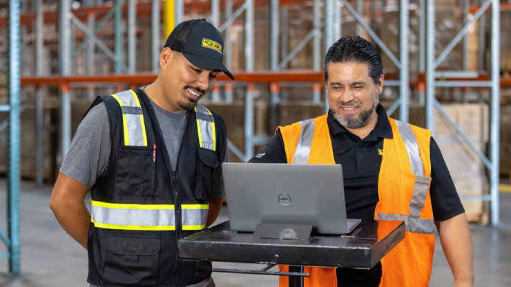 two j.b. hunt employees in a warehouse