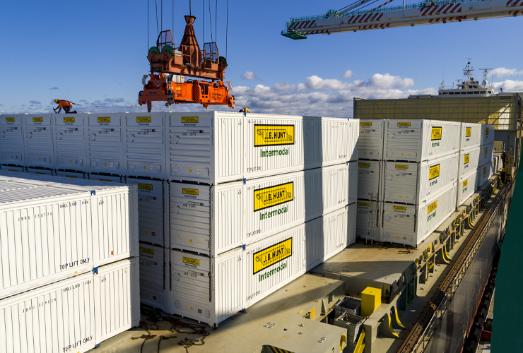 Intermodal containers being lifted by a crane